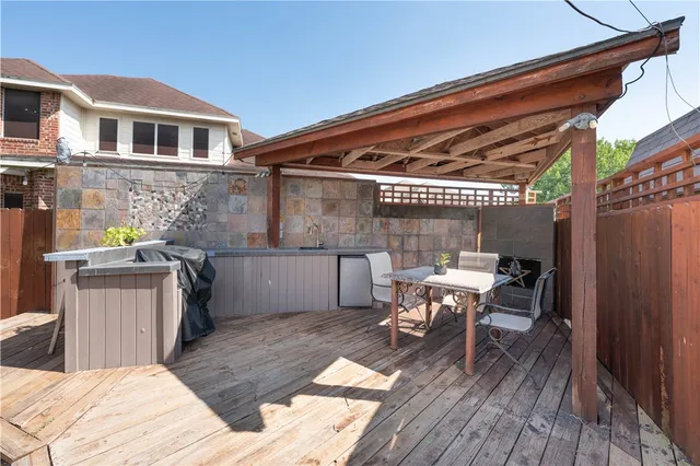 a patio with glass top table and chairs