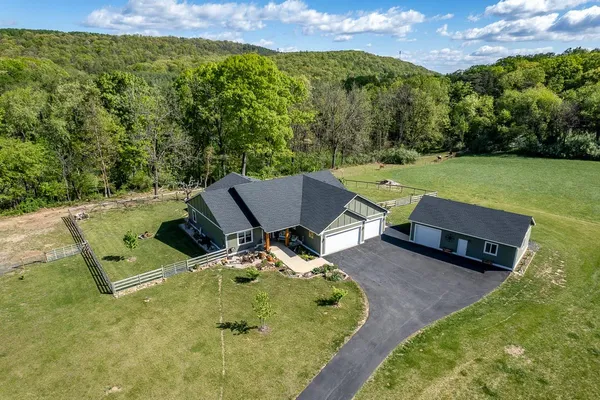 a view of backyard with swimming pool and outdoor seating