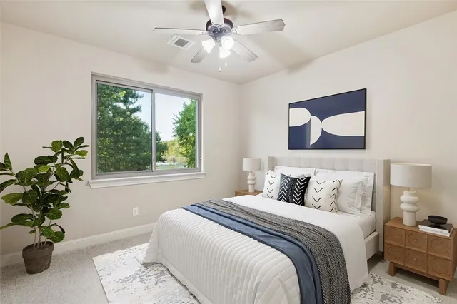 a bedroom with a balcony a bed and a potted plant