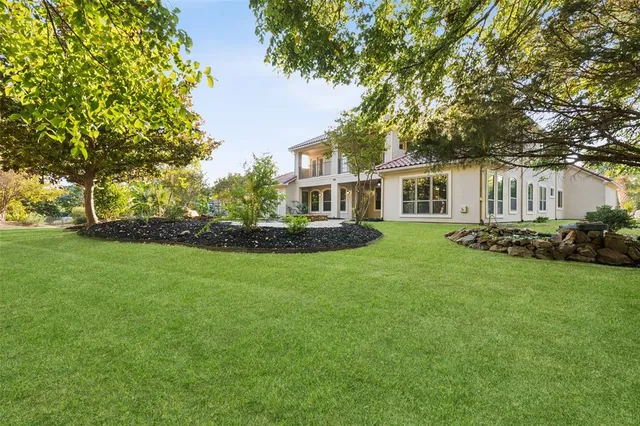 a front view of a house with a yard table and chairs