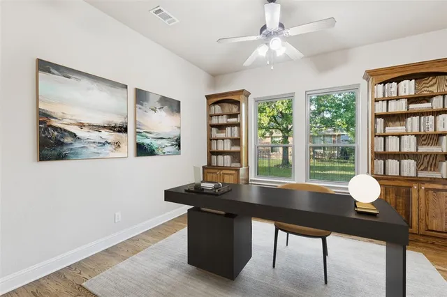 a view of a workspace with furniture and a potted plant