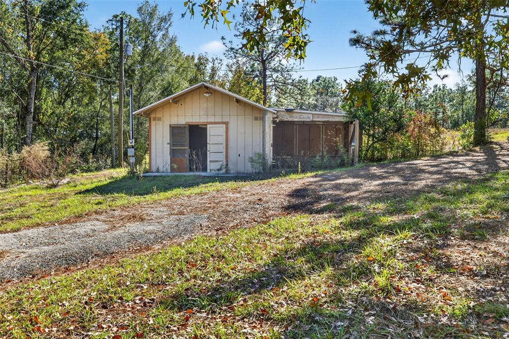 14252 Trinity Road Brooksville, FL 34614 - Photo 22 of 26 a front view of a house with a yard and tree