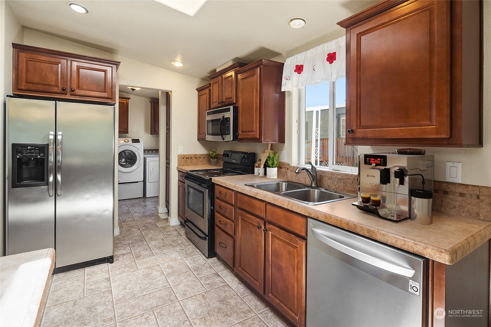 815 Southwest 124th Street, Unit 149 Everett, WA 98204 - Photo 10 of 35 a kitchen with stainless steel appliances granite countertop a sink refrigerator and microwave