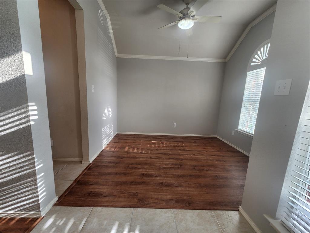 8313 Fountain Ridge Drive Plano, TX 75025 - Photo 13 of 24 a view of an empty room with wooden floor and a window