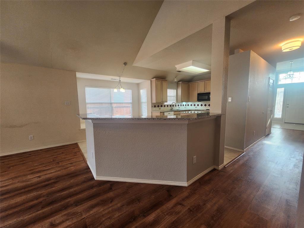 8313 Fountain Ridge Drive Plano, TX 75025 - Photo 20 of 24 a kitchen with wooden floors and refrigerator