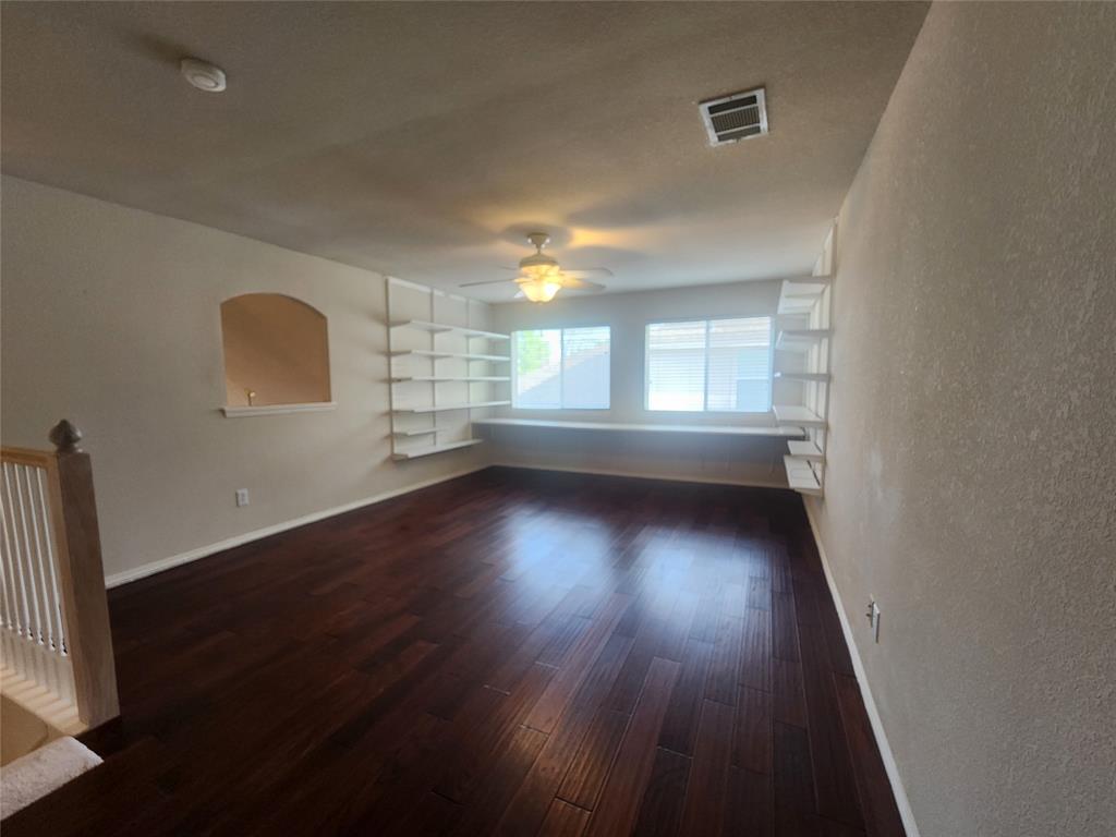 8313 Fountain Ridge Drive Plano, TX 75025 - Photo 6 of 24 an empty room with wooden floor and windows