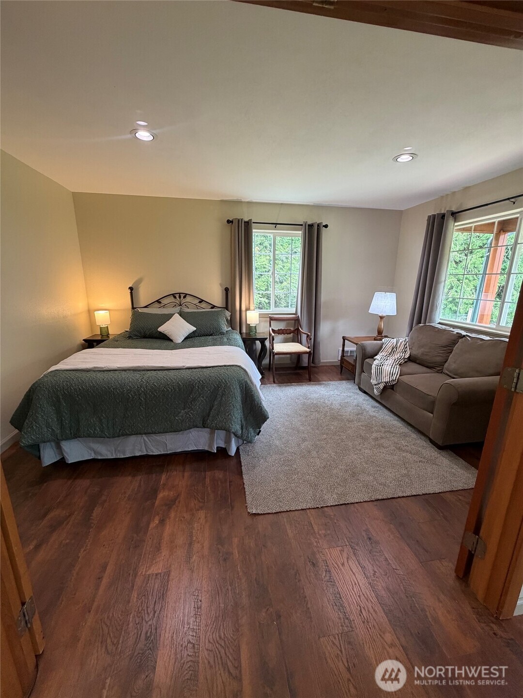 561 Country Acres Lane Sequim, WA 98382 - Photo 11 of 37 a bedroom with a bed and wooden floor