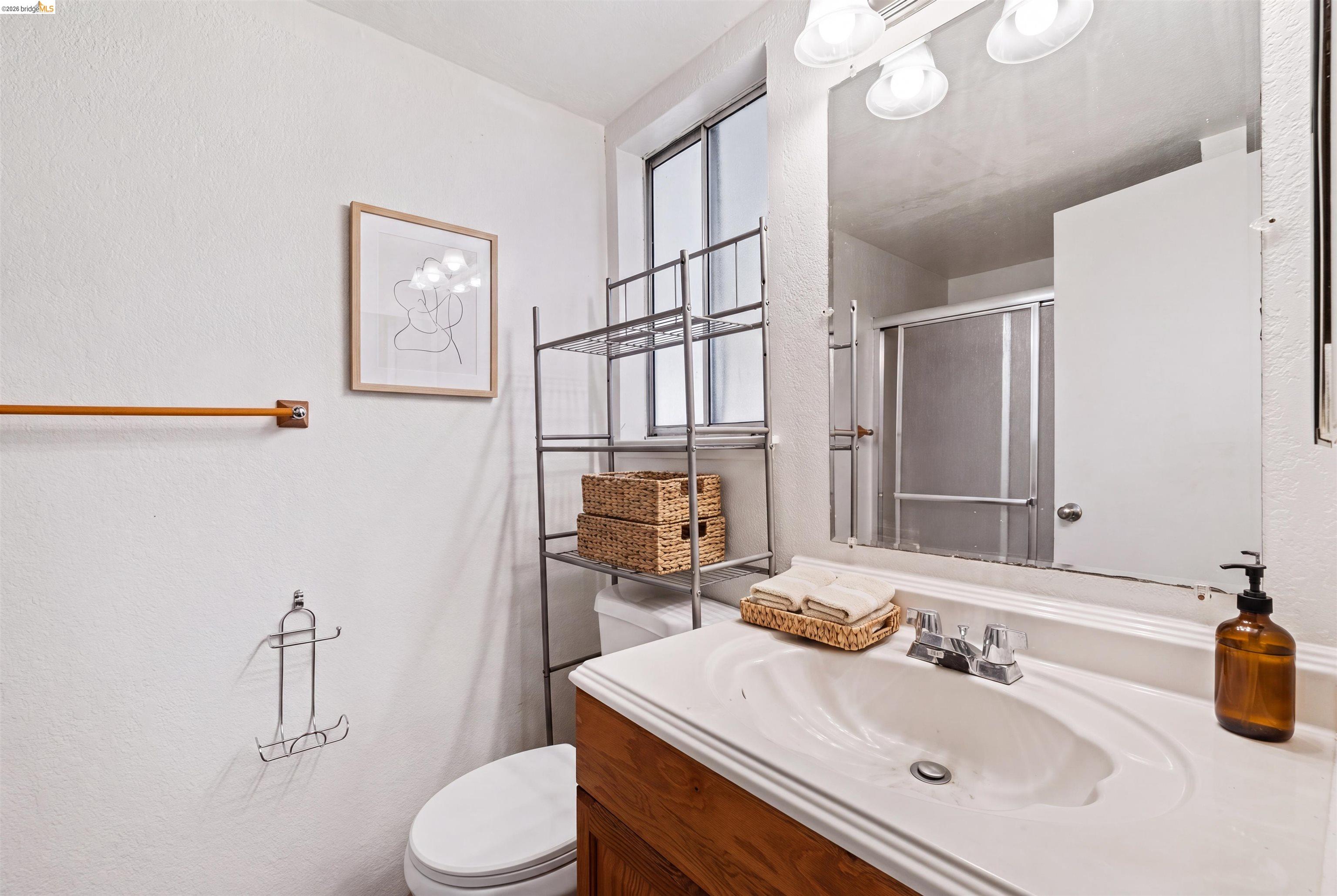 1151 Chadwick Circle Bay Point, CA 94565 - Photo 22 of 23 Bathroom featuring a wood-finish vanity with an integrated sink and chrome faucet