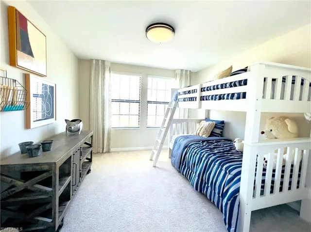 a bedroom with furniture and a window