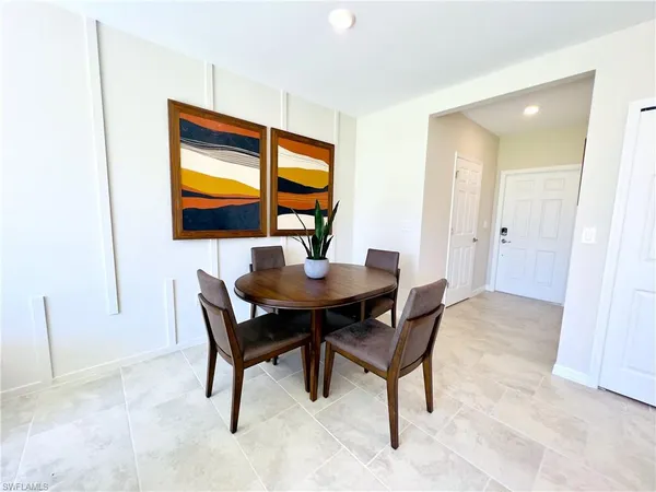 a dining room with furniture and window