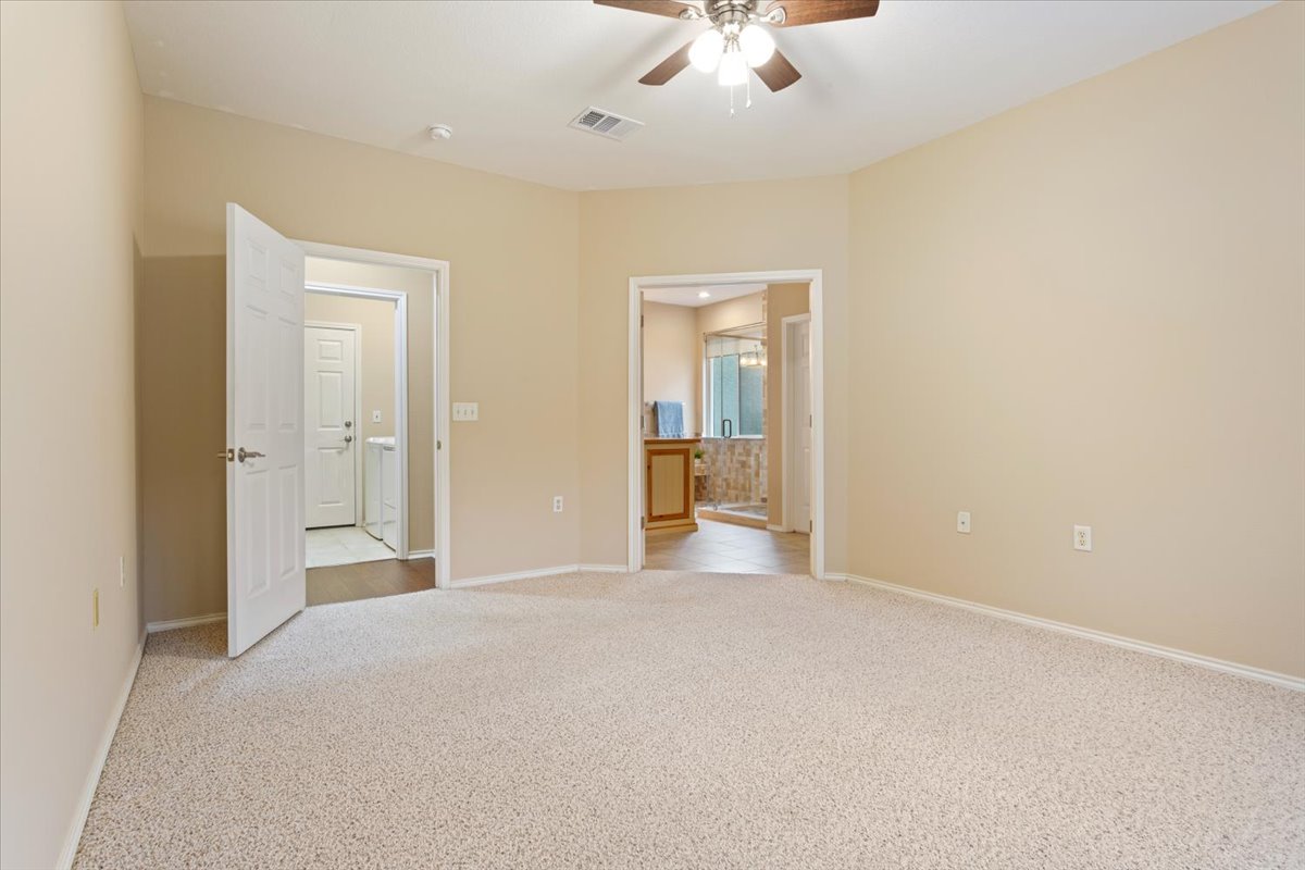 246 Red Poppy Trail Georgetown, TX 78633 - Photo 19 of 32 a view of a livingroom with a chandelier fan and a bathroom