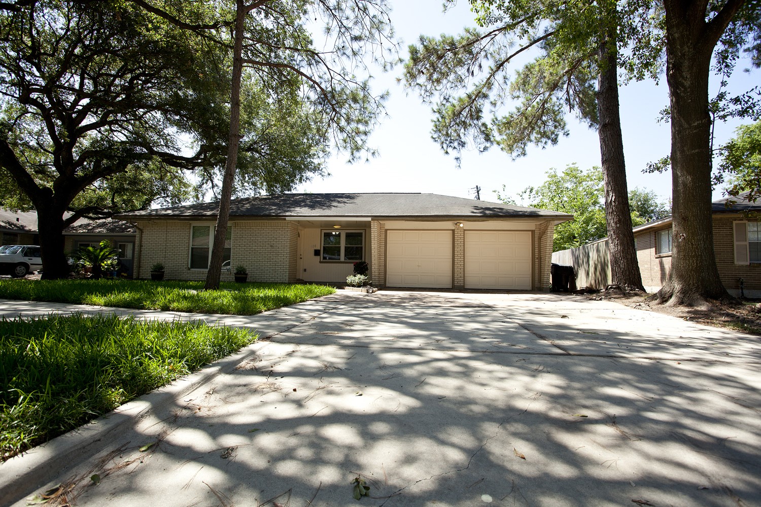 a view of a house with a tree in front of it