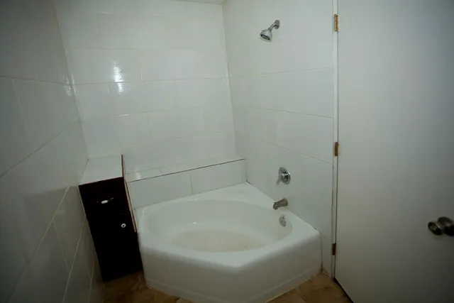 a white toilet sitting next to a small sink