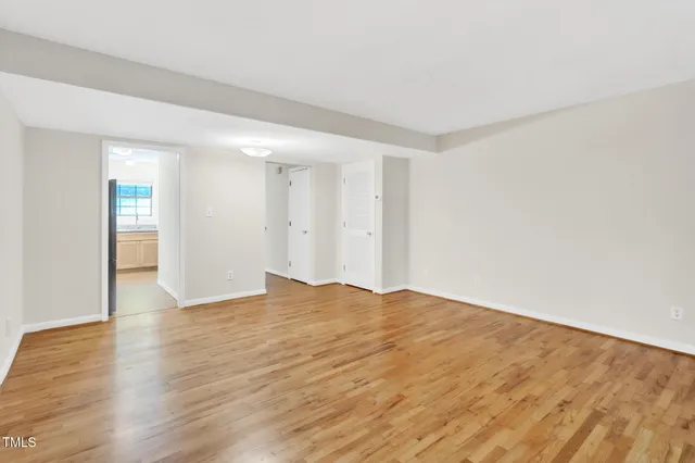 a view of an empty room and wooden floor