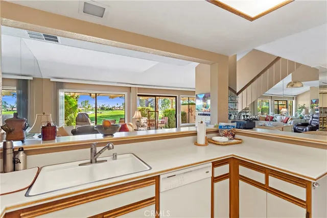 a kitchen with sink and large window