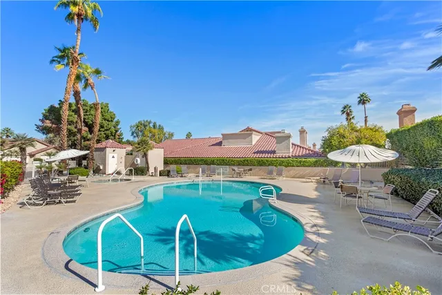 a view of a swimming pool with a table and chairs