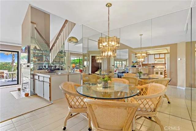 a dining table with chairs and chandelier