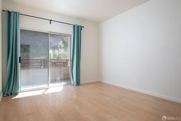 a view of an empty room with glass door