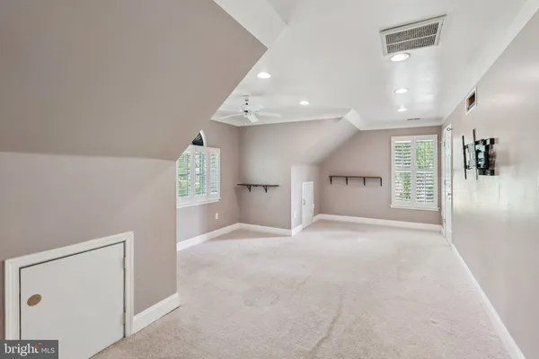 a bathroom with a sink toilet a mirror and window