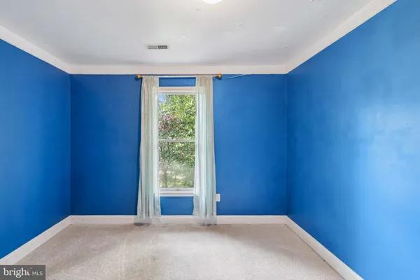a view of an empty room with glass door