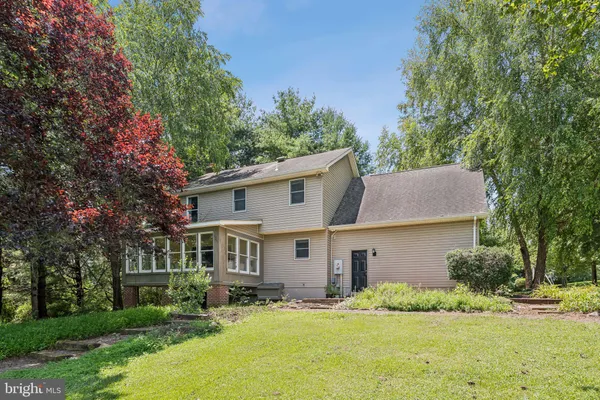 a living room with furniture and a large window with wooden floor
