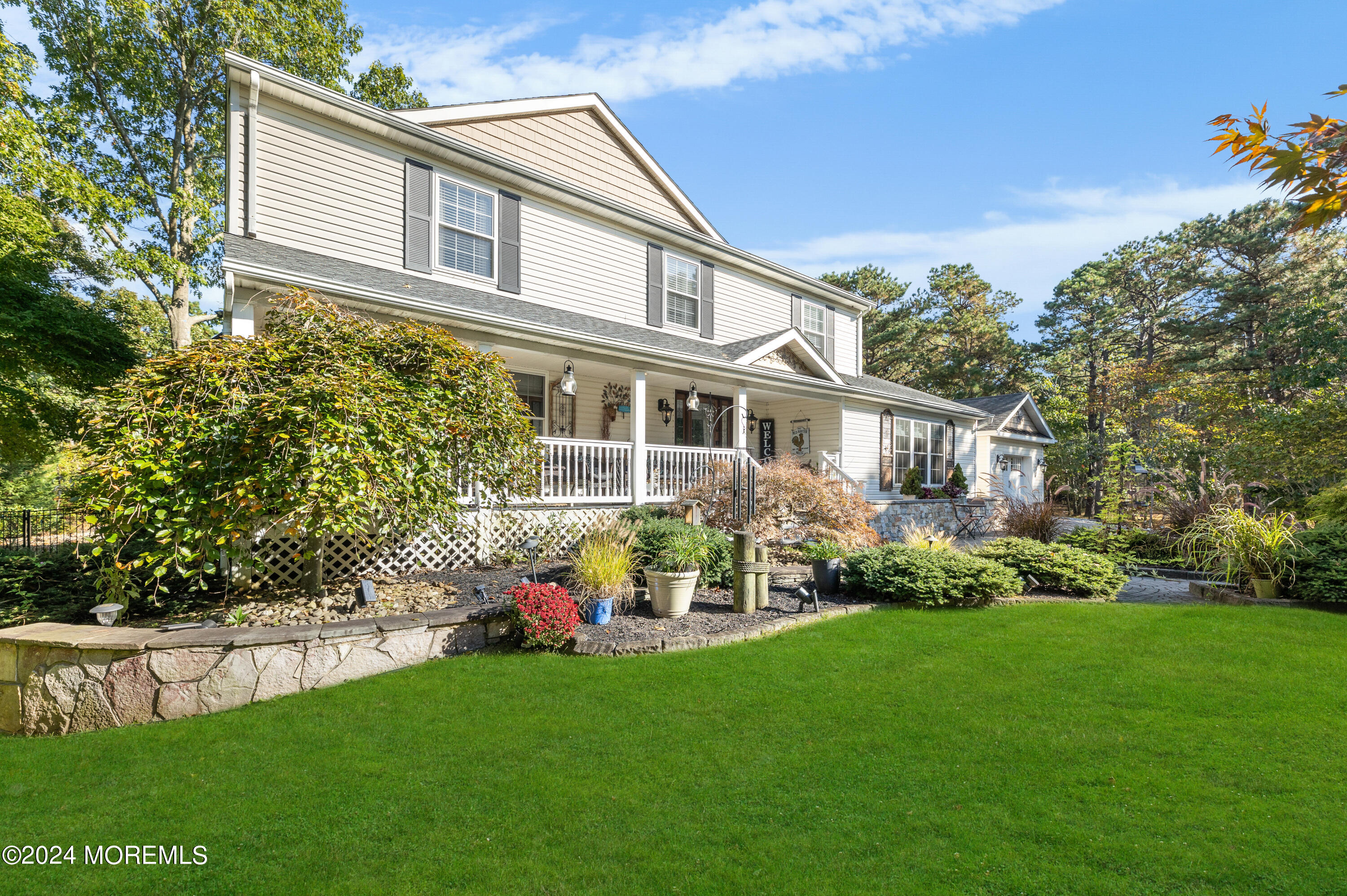 159 Arnold Boulevard Howell, NJ 07731 - Photo 4 of 60 a front view of a house with a garden and plants