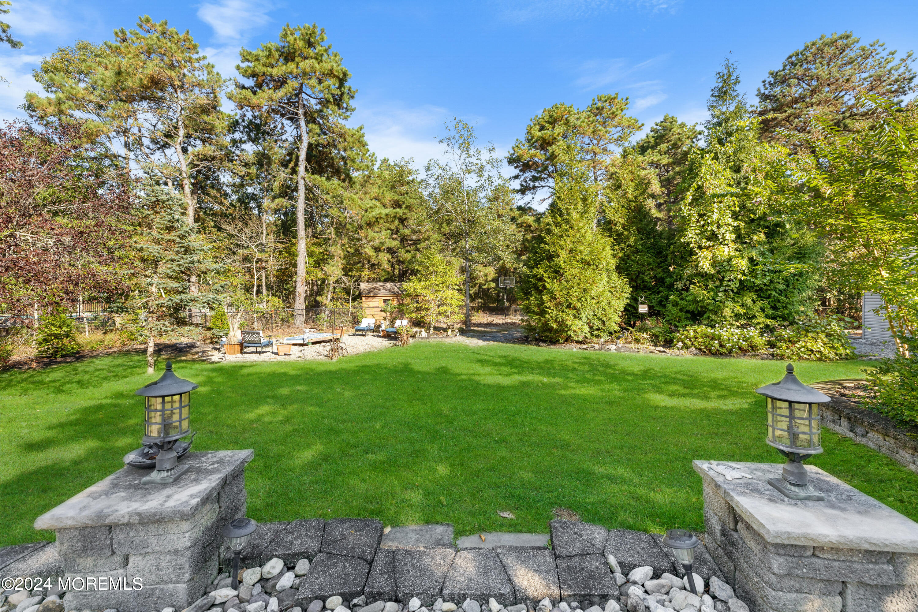 159 Arnold Boulevard Howell, NJ 07731 - Photo 56 of 60 a view of a garden with a building in the background