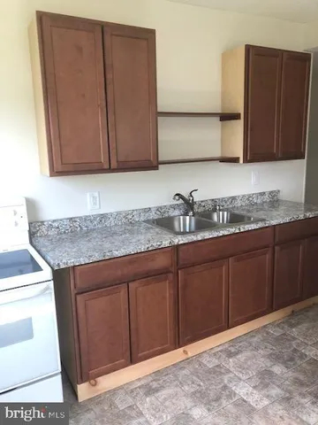 a kitchen with granite countertop cabinets and window