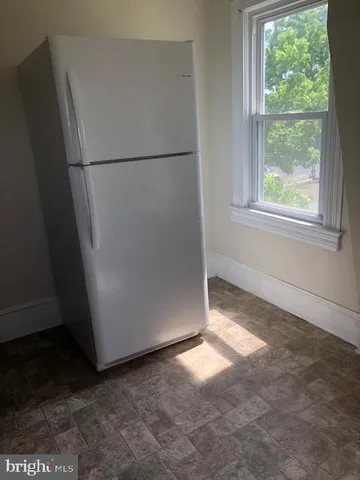 a view of empty room with closet and window