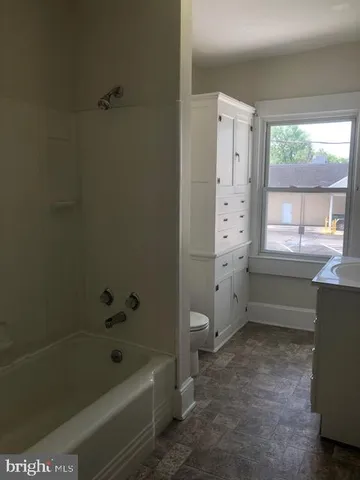 a bathroom with a bathtub a toilet and a shower