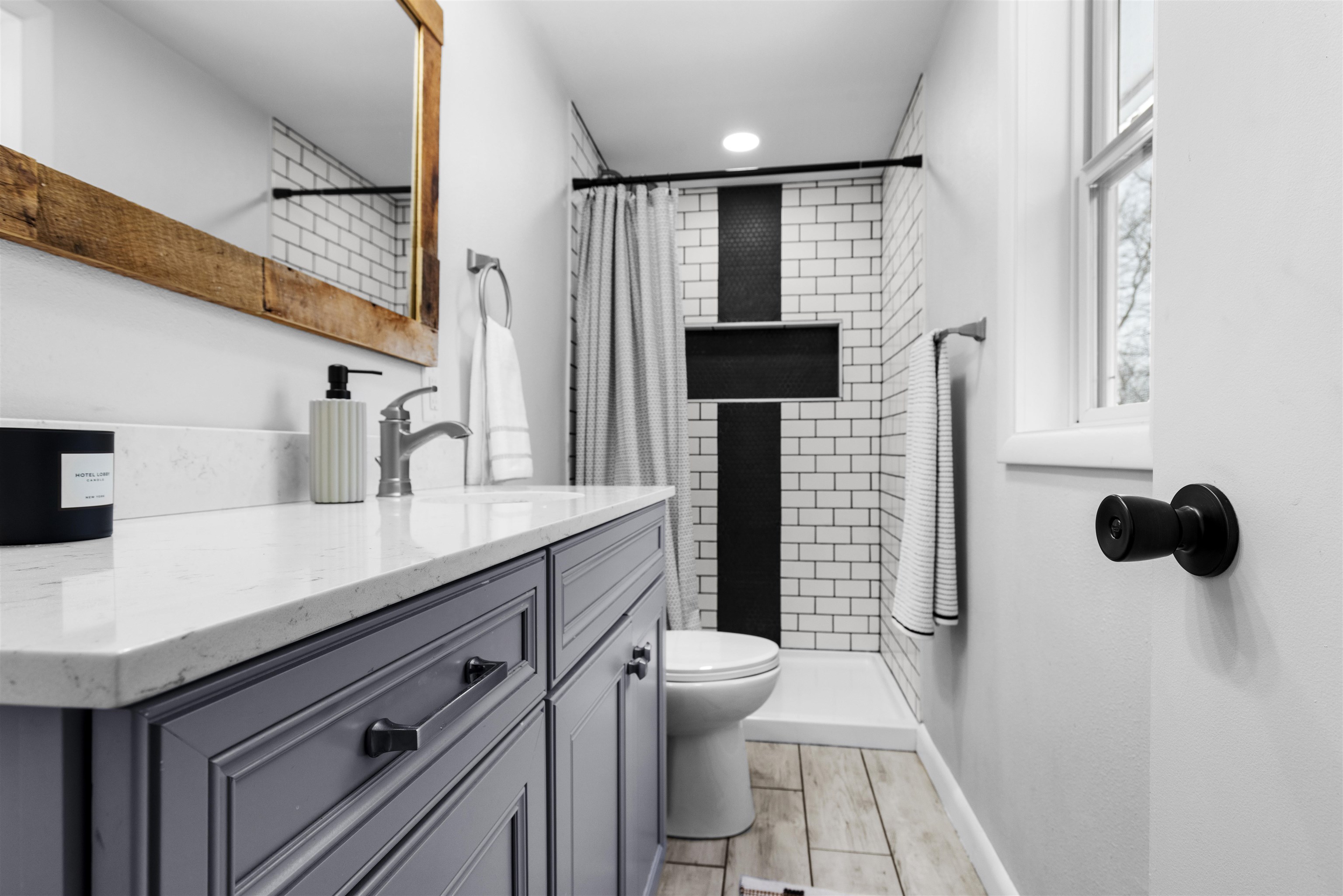 5150 Guilford Road Rockford, IL 61107 - Photo 17 of 33 a bathroom with a sink a toilet a mirror and shower