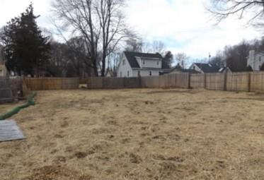 View of yard featuring fence