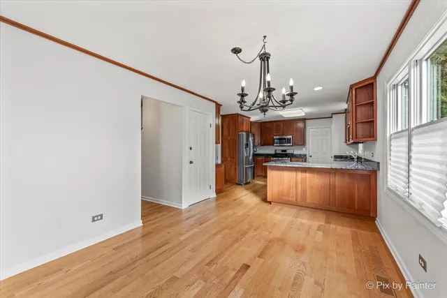 a large kitchen with granite countertop a large counter top and stainless steel appliances