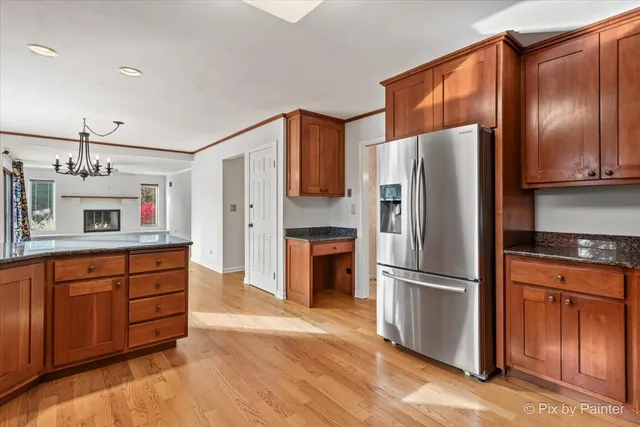 a kitchen with granite countertop stainless steel appliances a refrigerator and microwave
