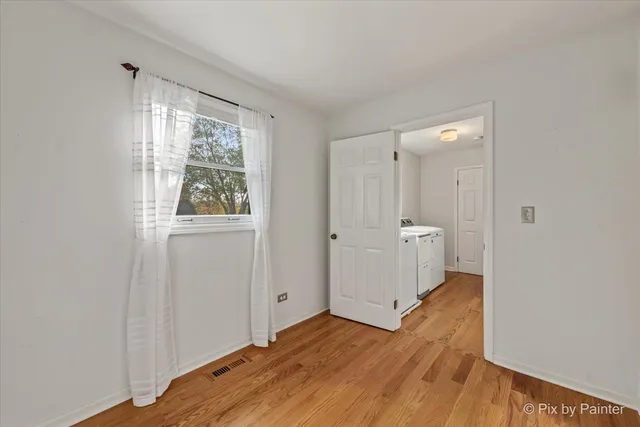 a view of a room with wooden floor and window
