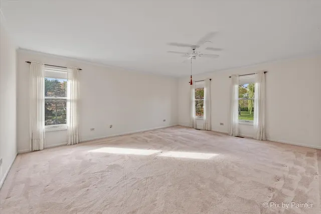 an empty room with windows and closet