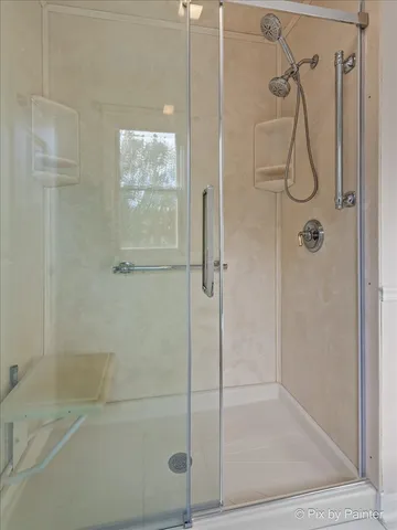 a bathroom with a glass shower door
