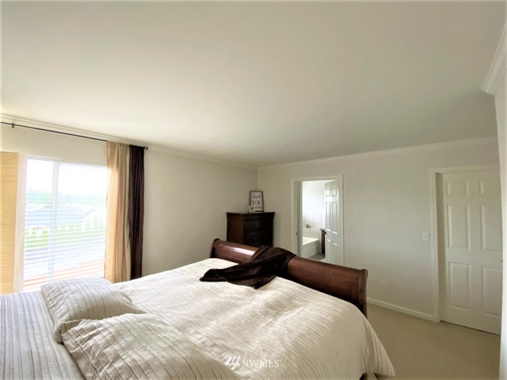 35127 11th Place Southwest Federal Way, WA 98023 - Photo 20 of 31 a bedroom with a large bed and a tv