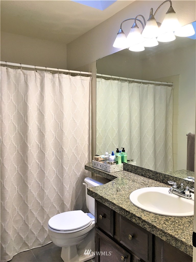 35127 11th Place Southwest Federal Way, WA 98023 - Photo 29 of 31 a bathroom with a granite countertop sink toilet and a mirror