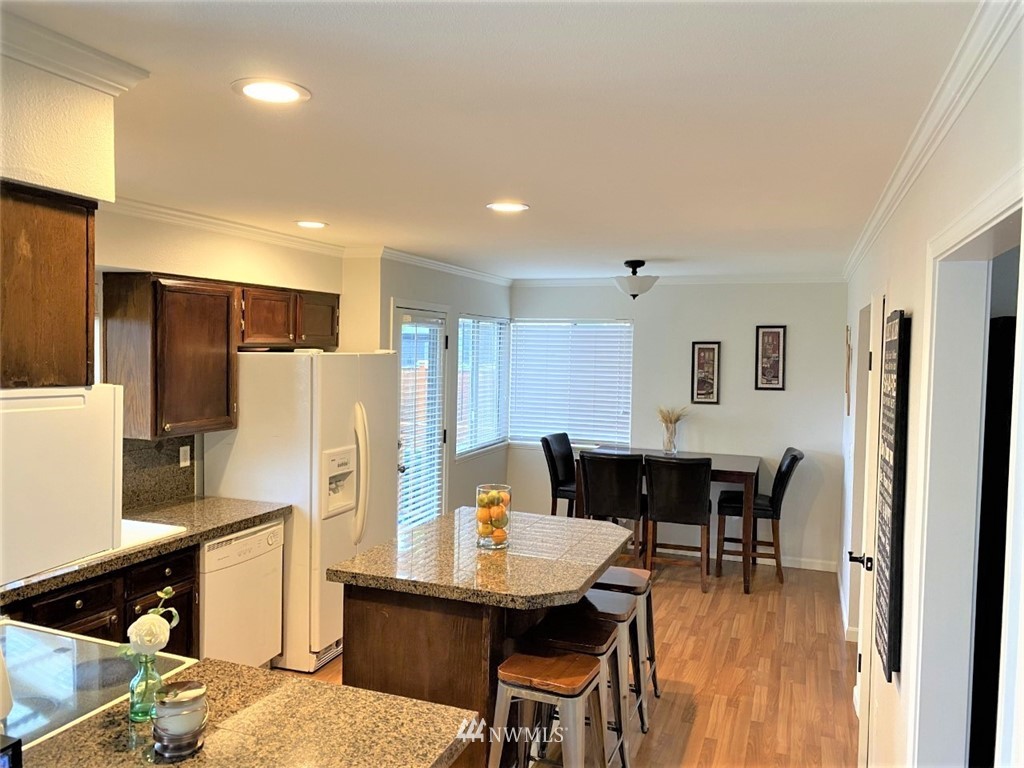 35127 11th Place Southwest Federal Way, WA 98023 - Photo 9 of 31 a kitchen with stainless steel appliances refrigerator dining table and chairs