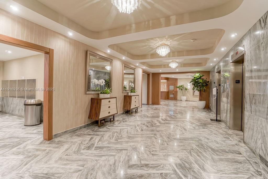 5401 Collins Avenue, Unit 1512 Miami Beach, FL 33140 - Photo 12 of 40 a view of a hallway with wooden shelves