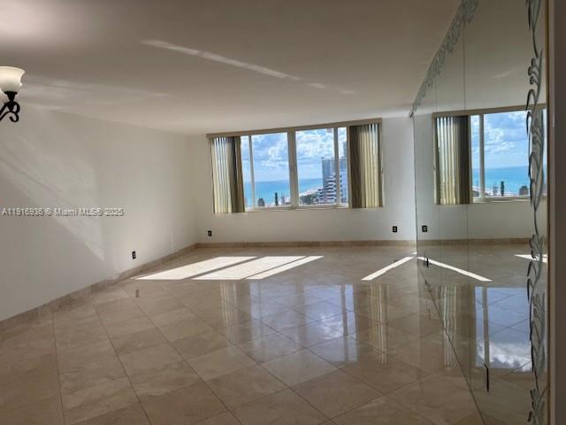 5401 Collins Avenue, Unit 1512 Miami Beach, FL 33140 - Photo 20 of 40 an empty room with wooden floor and windows
