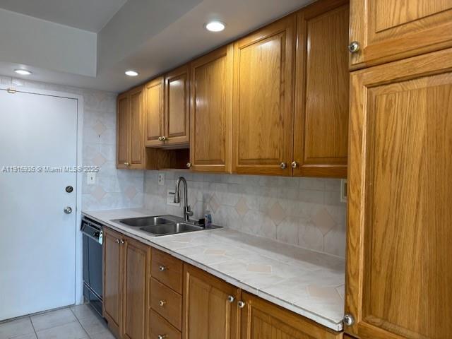 5401 Collins Avenue, Unit 1512 Miami Beach, FL 33140 - Photo 24 of 40 a kitchen with a sink a counter top space and cabinets