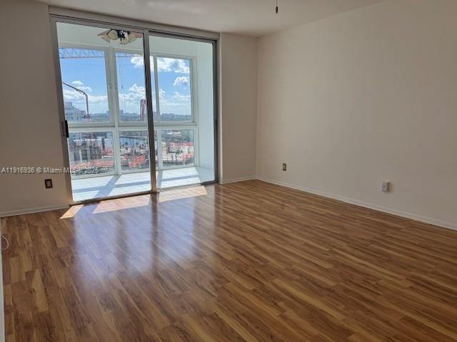 5401 Collins Avenue, Unit 1512 Miami Beach, FL 33140 - Photo 26 of 40 wooden floor in an empty room with a window