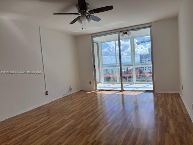 5401 Collins Avenue, Unit 1512 Miami Beach, FL 33140 - Photo 27 of 40 a view of room with wooden floor and fan