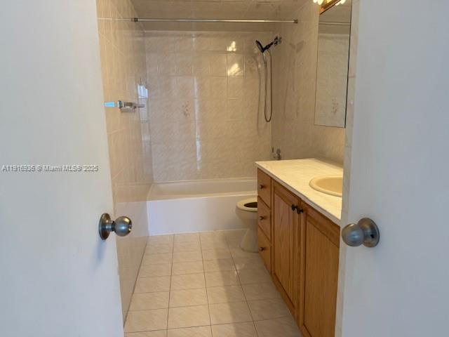 5401 Collins Avenue, Unit 1512 Miami Beach, FL 33140 - Photo 29 of 40 a bathroom with a granite countertop sink a toilet and shower