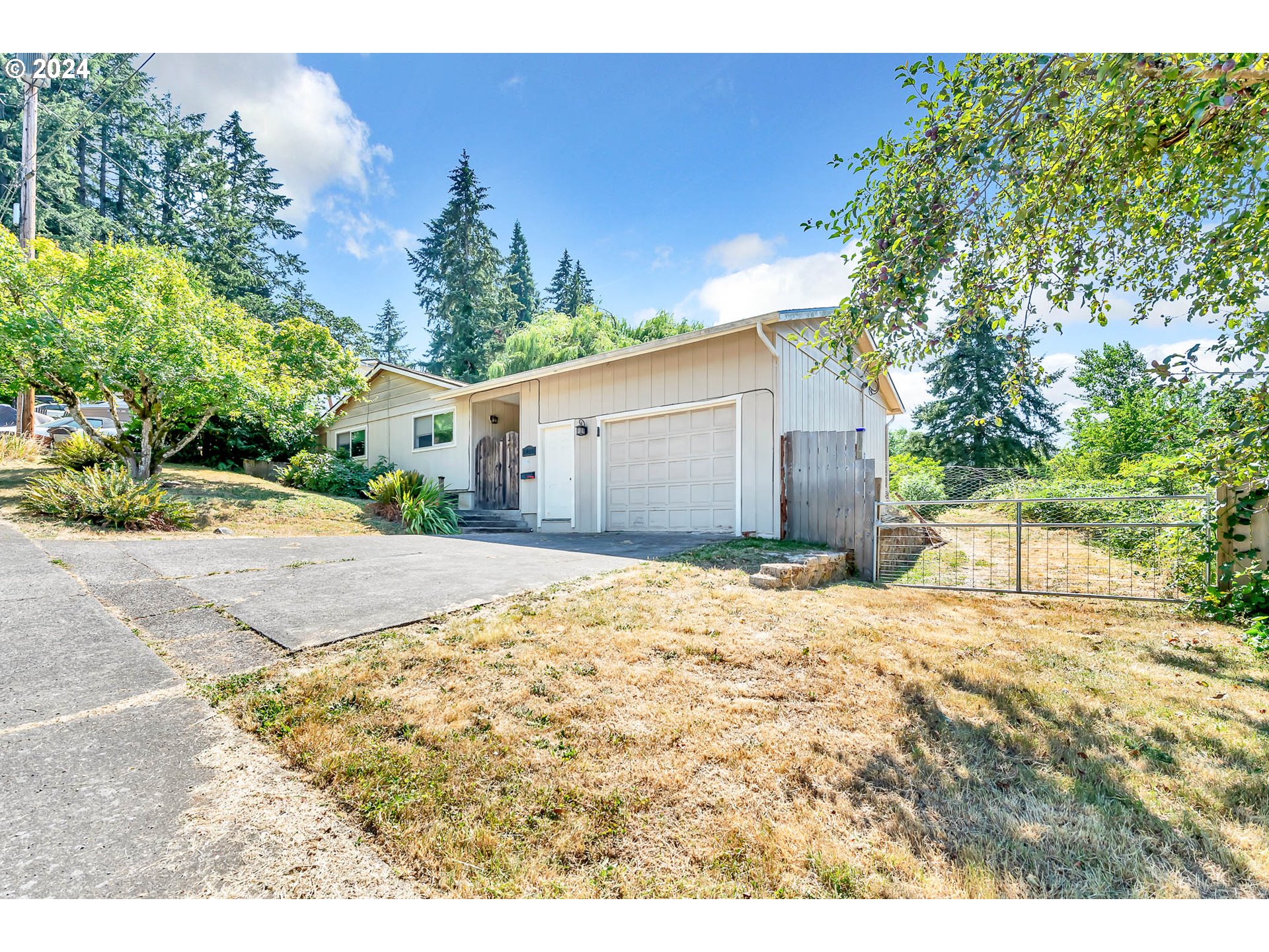 5000 Whiteaker Street Eugene, OR 97405 - Photo 3 of 18 a backyard of a house with a yard and garage