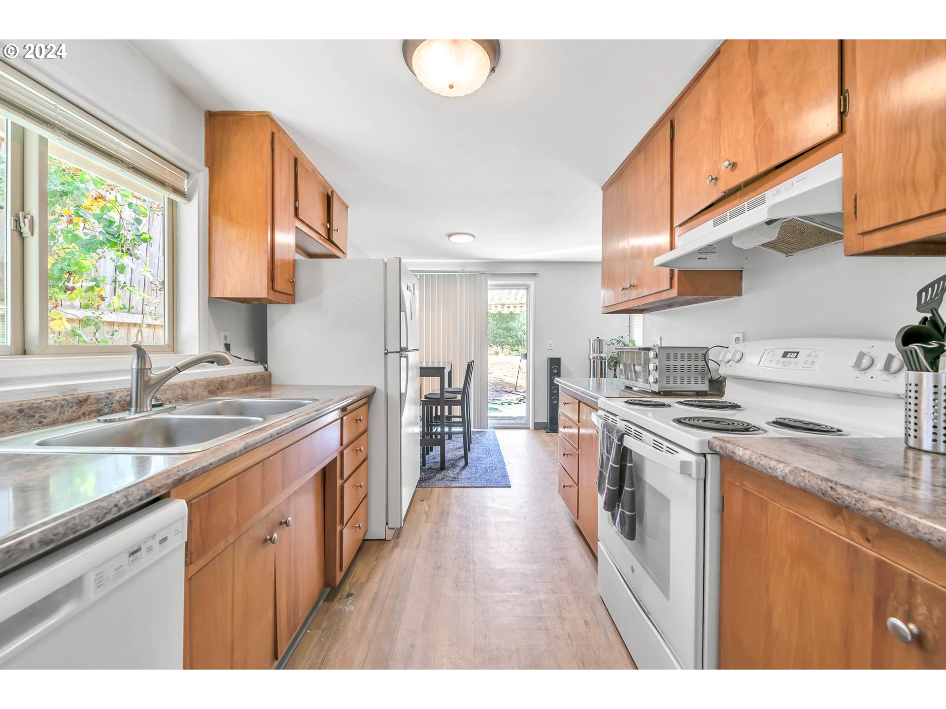 5000 Whiteaker Street Eugene, OR 97405 - Photo 8 of 18 a kitchen with stainless steel appliances granite countertop a stove a sink and a refrigerator