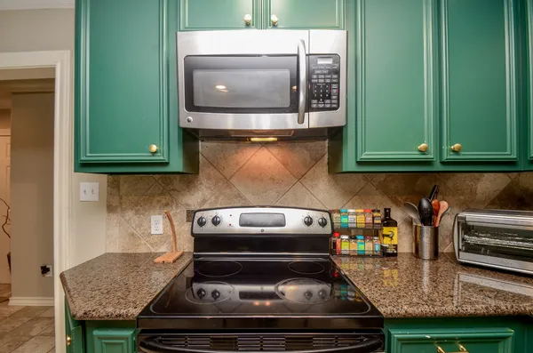 a kitchen with a stove and a microwave