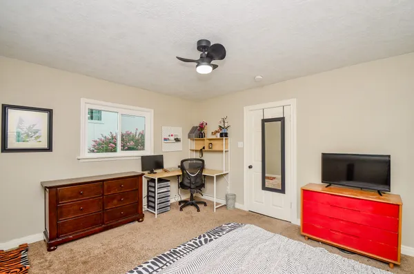 a view of a workspace with furniture and a window